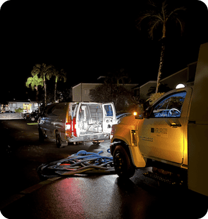 A truck and some cars parked on the side of a road.